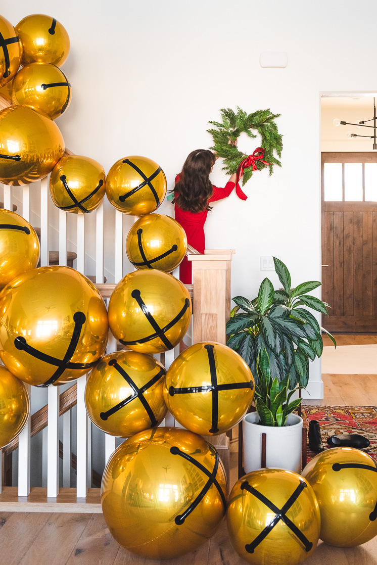 balloon garland of oversized christmas jingle balls on staircase