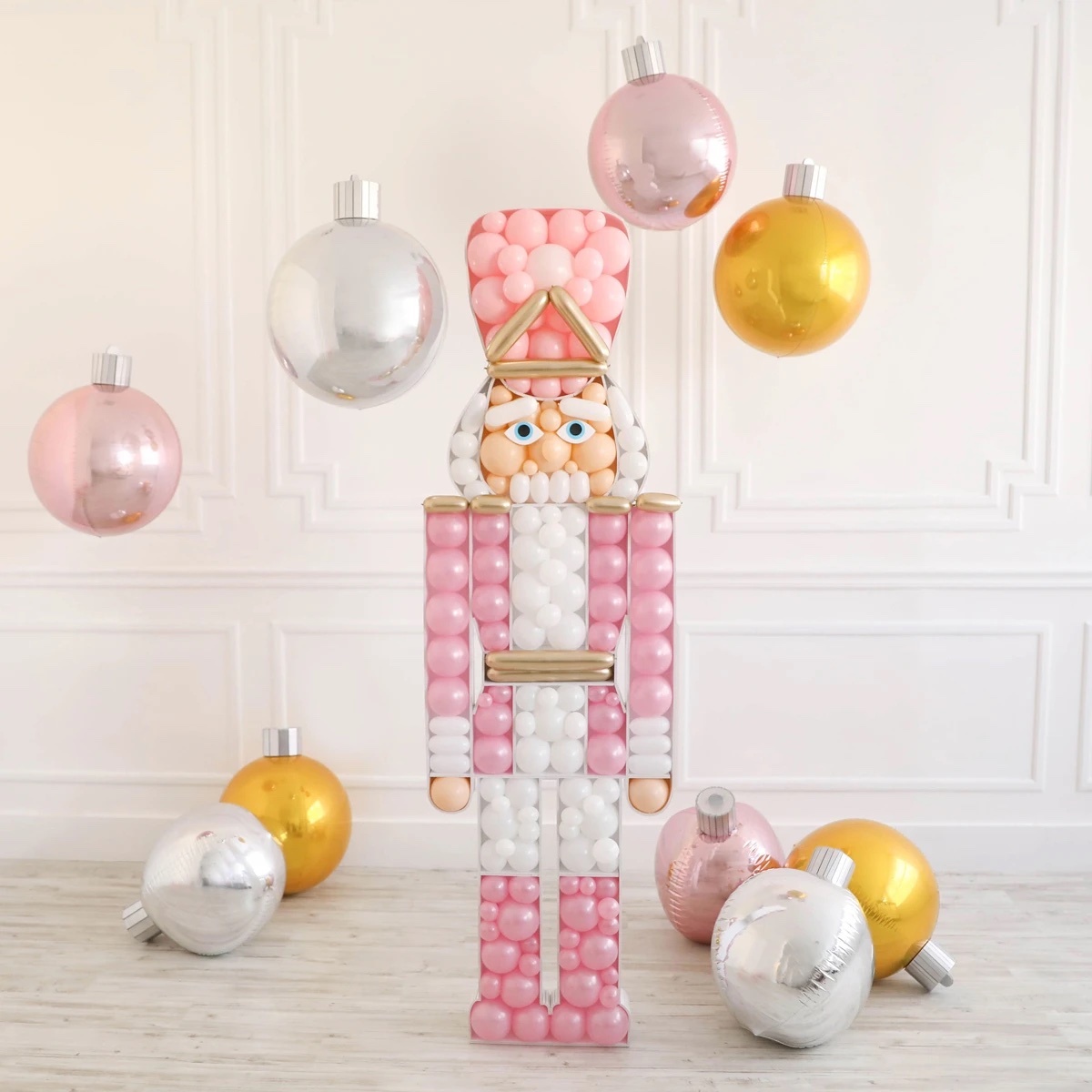 nutcracker display made with pink and white balloons