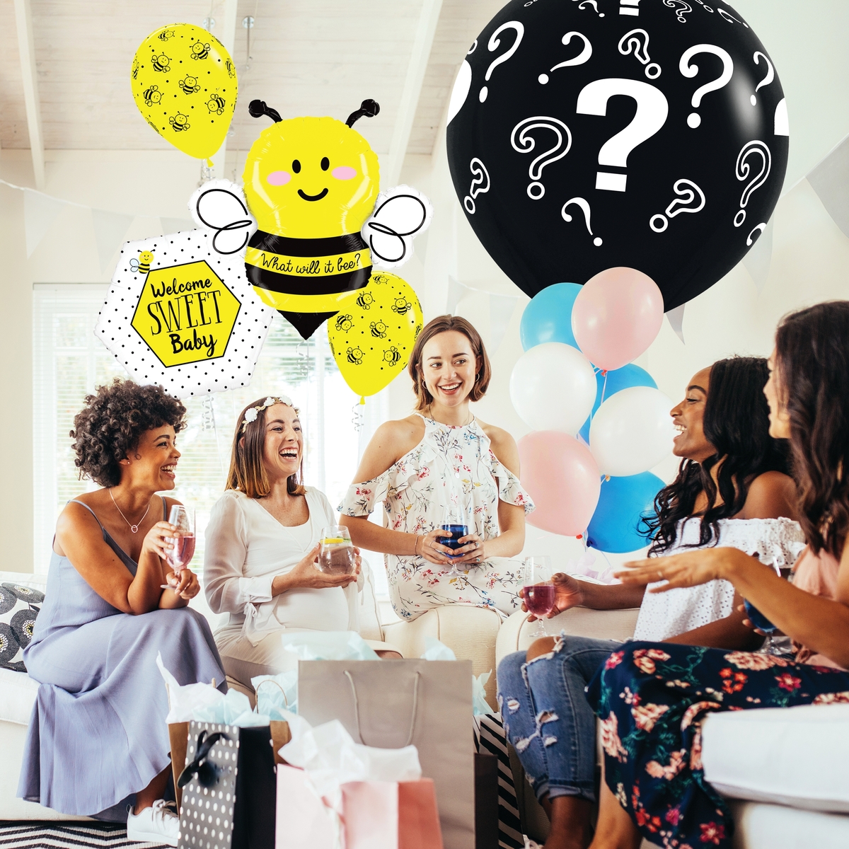 baby gender reveal with bumble bee balloons